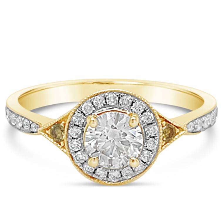 Yellow Gold engagement ring featuring a .50ct FG Si1 centre diamond. Surrounded by a halo of diamonds and shoulders featuring two yellow diamonds