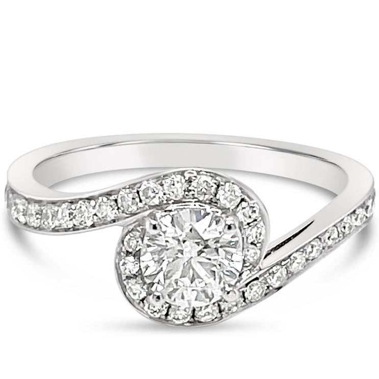 Promise perfection with this unique diamond set wrap around band engagement ring. While slightly similar to a halo, this ring has a unique design with the band that highlight the centre diamond.