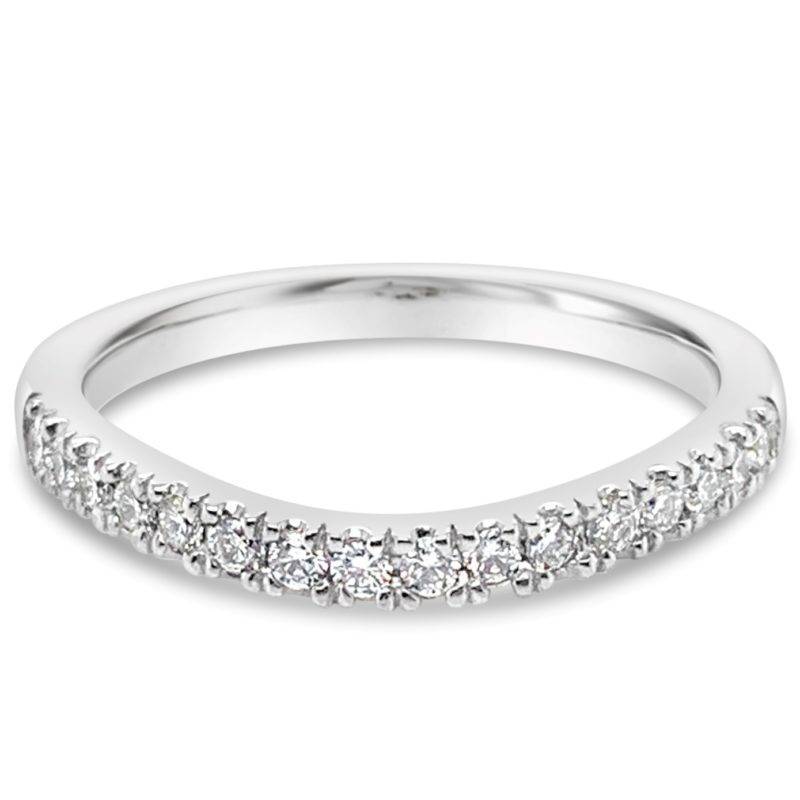 Wedding Band featuring a soft curve, making it suitable to fit around an engagement ring. This wedding band is crafted in 18ct White Gold consisting of a total diamond weight of 0.24ct